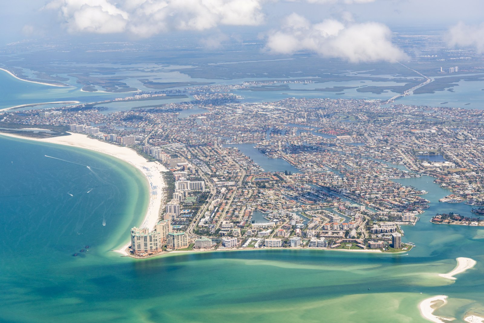 Aerial photograph of Marco Island, showing the crescent of South Beach, the inland canals and the Gulf of Mexico stretching west.
